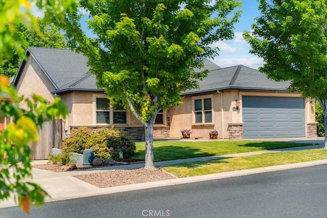 1968 Bancroft Dr, Chico, CA 95928 - view of property hidden behind natural elements featuring stucco siding, stone siding, an attached garage, driveway, and roof with shingles