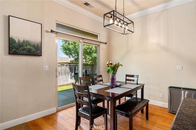 1968 Bancroft Dr, Chico, CA 95928 - dining room featuring a chandelier, light wood-style flooring, and ornamental molding