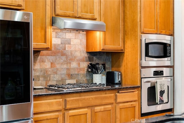 1968 Bancroft Dr, Chico, CA 95928 - kitchen featuring appliances with stainless steel finishes, under cabinet range hood, backsplash, and dark stone countertops
