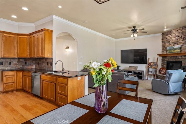 1968 Bancroft Dr, Chico, CA 95928 - kitchen featuring stainless steel dishwasher, arched walkways, ceiling fan, brown cabinetry, and recessed lighting