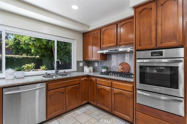 3125 Yukon Ave, Costa Mesa, CA 92626 - kitchen featuring stainless steel appliances, a warming drawer, under cabinet range hood, tasteful backsplash, and light stone countertops