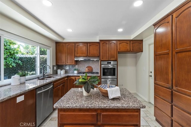 3125 Yukon Ave, Costa Mesa, CA 92626 - kitchen with stainless steel appliances, under cabinet range hood, dark stone countertops, decorative backsplash, and recessed lighting