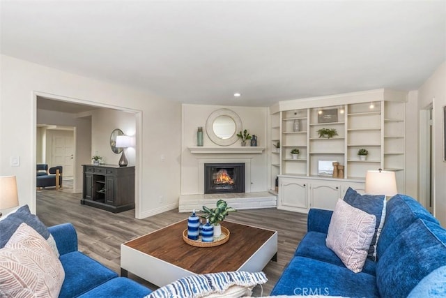 3125 Yukon Ave, Costa Mesa, CA 92626 - living area with a warm lit fireplace, wood finished floors, and recessed lighting