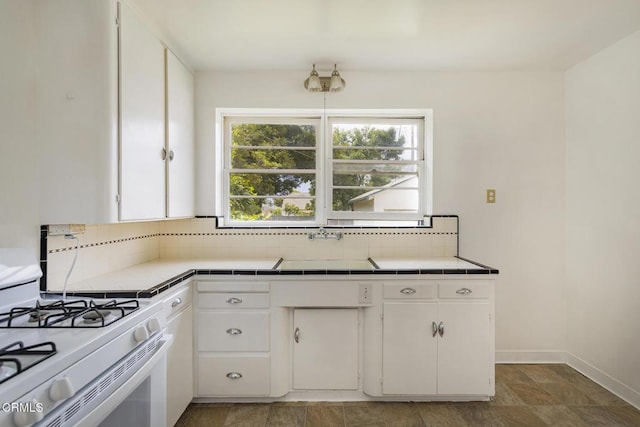 237 N Katherine Dr, Ventura, CA 93003 - kitchen featuring tile counters, white gas stove, backsplash, and white cabinetry