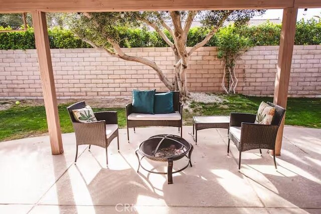 30319 Desert Moon Dr, Thousand Palms, CA 92276 - fenced backyard featuring an outdoor living space with a fire pit and a patio