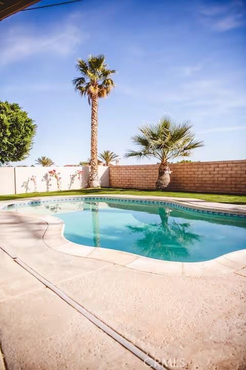 30319 Desert Moon Dr, Thousand Palms, CA 92276 - view of swimming pool with a fenced backyard and a patio