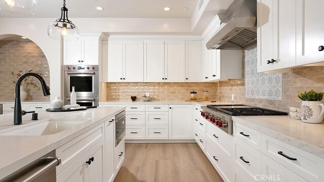 501 Elena Ln Unit A, San Clemente, CA 92672 - kitchen with extractor fan, appliances with stainless steel finishes, white cabinetry, decorative light fixtures, and recessed lighting