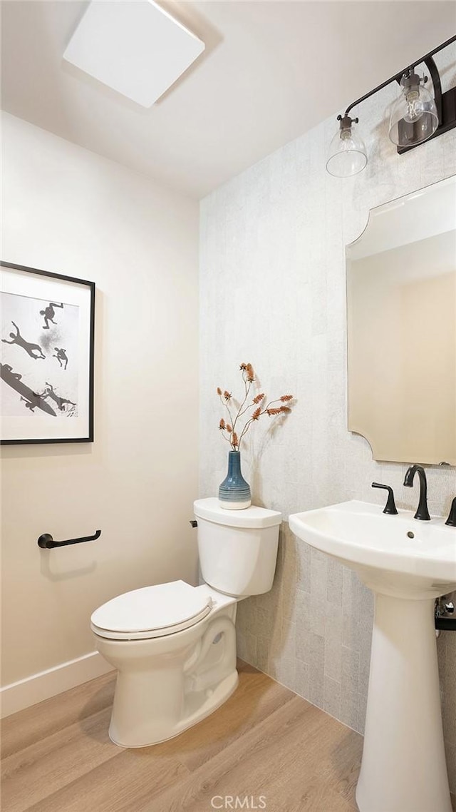 501 Elena Ln Unit A, San Clemente, CA 92672 - half bathroom featuring toilet and wood finished floors