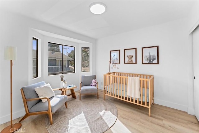 1262 E Ln Palma Ave Unit A, Anaheim, CA 92805 - bedroom featuring wood finished floors and a nursery area