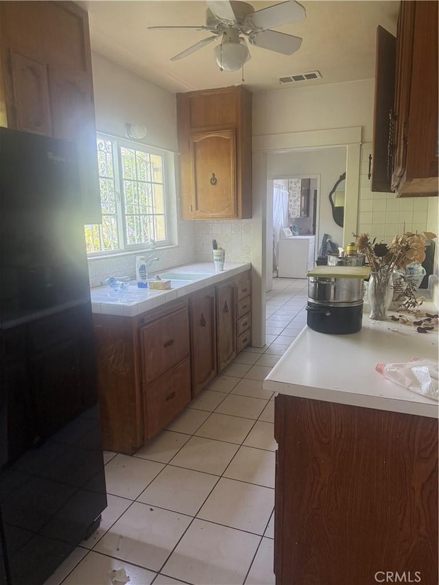 119 W Francis St, Corona, CA 92882 - kitchen with freestanding refrigerator, tasteful backsplash, a ceiling fan, and light tile patterned flooring