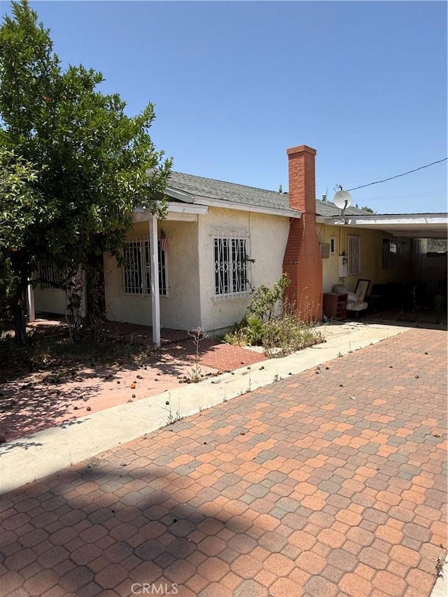 119 W Francis St, Corona, CA 92882 - view of front of house featuring a chimney and stucco siding