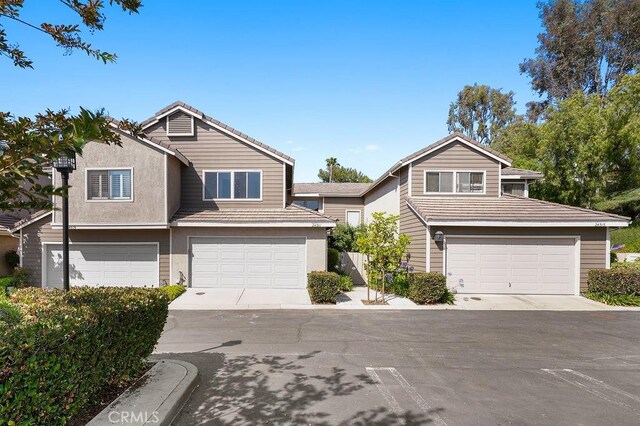24511 Sutton Ln, Laguna Niguel, CA 92677 - view of front of home featuring an attached garage, stucco siding, and driveway