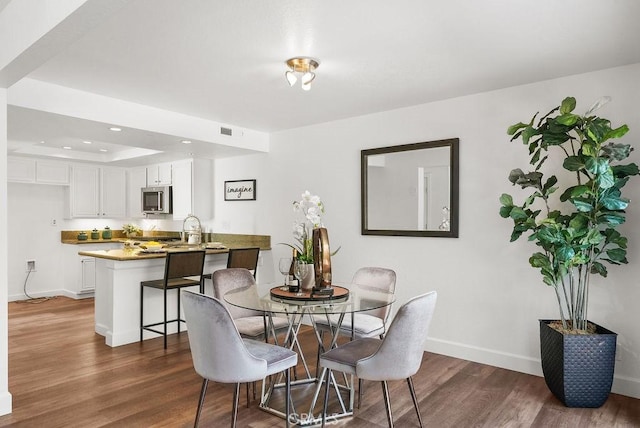 24511 Sutton Ln, Laguna Niguel, CA 92677 - dining space featuring dark wood-style floors, recessed lighting, and a tray ceiling