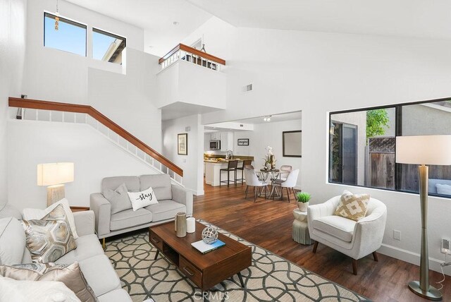 24511 Sutton Ln, Laguna Niguel, CA 92677 - living area with wood finished floors, stairs, plenty of natural light, and high vaulted ceiling