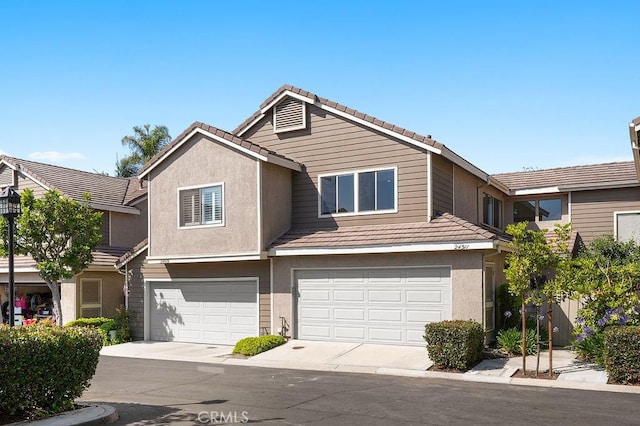 24511 Sutton Ln, Laguna Niguel, CA 92677 - view of property featuring a tiled roof, an attached garage, stucco siding, and driveway
