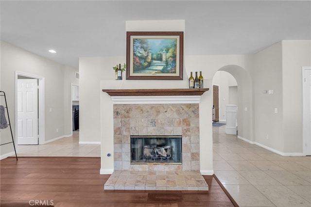 1775 Honors Ln, Corona, CA 92883 - unfurnished living room featuring arched walkways, a fireplace, recessed lighting, and light wood finished floors