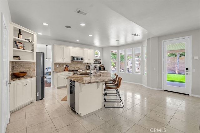 1775 Honors Ln, Corona, CA 92883 - kitchen with stainless steel microwave, backsplash, open shelves, healthy amount of natural light, and recessed lighting