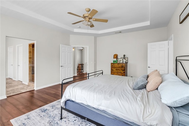 1775 Honors Ln, Corona, CA 92883 - bedroom with a tray ceiling, wood finished floors, and a ceiling fan