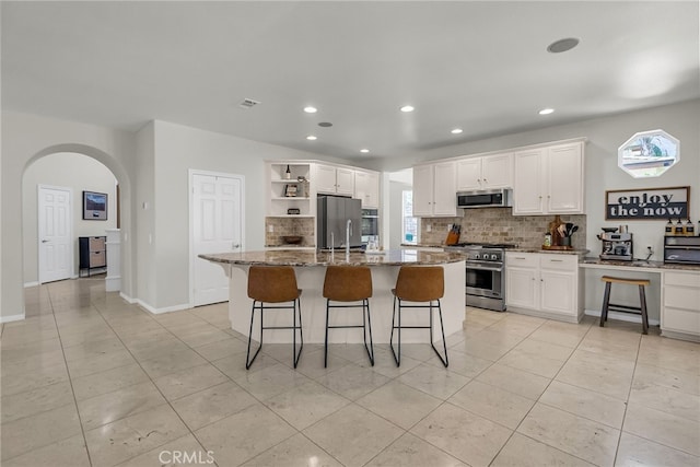 1775 Honors Ln, Corona, CA 92883 - kitchen with appliances with stainless steel finishes, open shelves, decorative backsplash, light tile patterned floors, and recessed lighting
