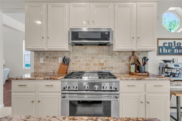 1775 Honors Ln, Corona, CA 92883 - kitchen with appliances with stainless steel finishes, decorative backsplash, light stone countertops, and white cabinetry
