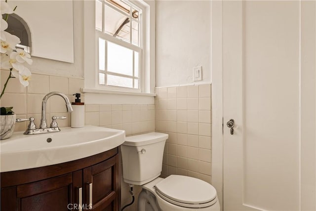 3848 Boyce Ave, Los Angeles, CA 90039 - half bathroom featuring tile walls, vanity, and a wainscoted wall