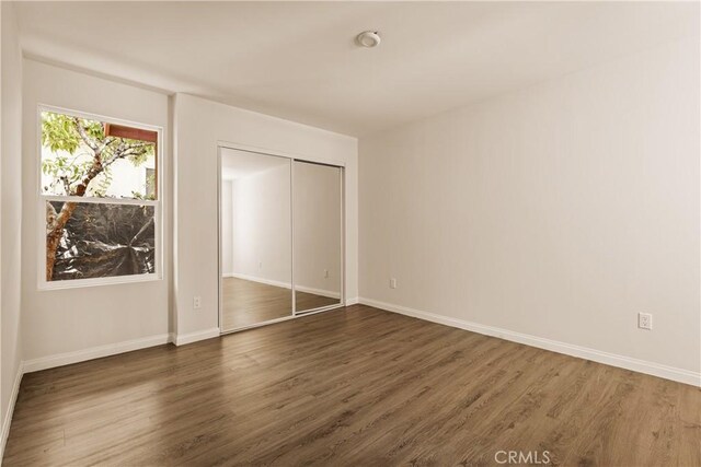 3848 Boyce Ave, Los Angeles, CA 90039 - unfurnished bedroom featuring dark wood-style flooring and a closet