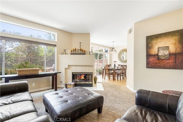 100 Stoney, Laguna Niguel, CA 92677 - carpeted living area with healthy amount of natural light, a fireplace, and a chandelier