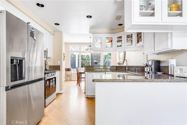 100 Stoney, Laguna Niguel, CA 92677 - kitchen featuring stainless steel appliances, a peninsula, light wood-style flooring, white cabinets, and stone counters