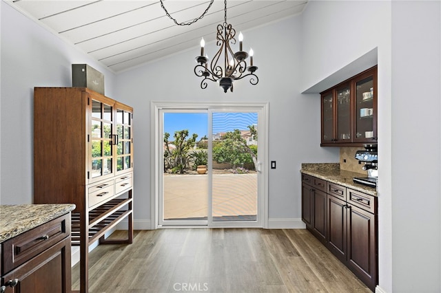 24191 Vis D Oro, Dana Point, CA 92629 - unfurnished dining area featuring light wood-style floors, a chandelier, and high vaulted ceiling