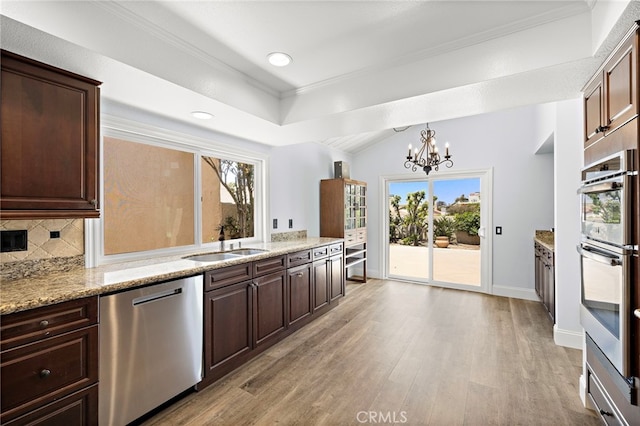 24191 Vis D Oro, Dana Point, CA 92629 - kitchen with appliances with stainless steel finishes, a raised ceiling, light wood finished floors, a chandelier, and dark brown cabinets