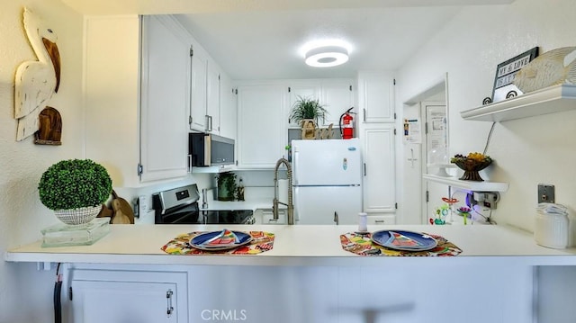 6924 Hyde Park Dr Unit 106, San Diego, CA 92119 - kitchen featuring stainless steel appliances, a peninsula, white cabinets, and light countertops