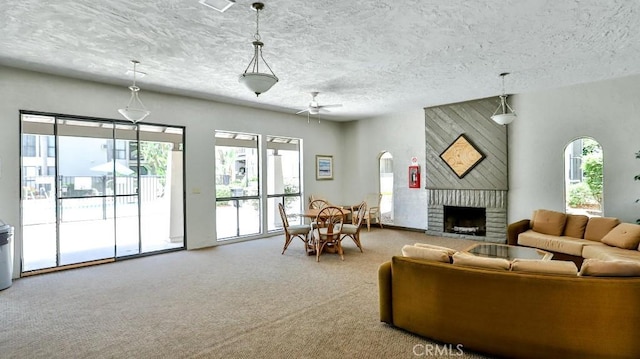 6924 Hyde Park Dr Unit 106, San Diego, CA 92119 - living room featuring healthy amount of natural light, a textured ceiling, a fireplace, carpet, and ceiling fan