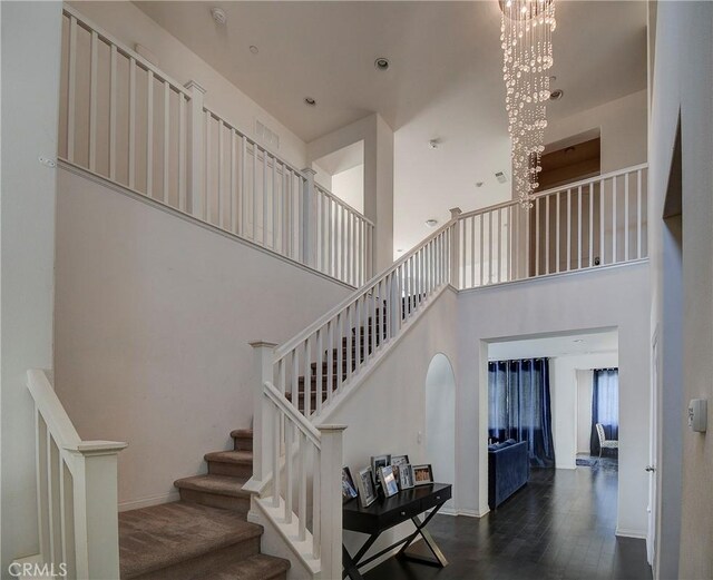 1855 W Willow Ave, Anaheim, CA 92804 - staircase featuring a chandelier, a towering ceiling, and wood finished floors