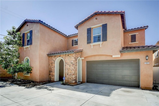 1855 W Willow Ave, Anaheim, CA 92804 - mediterranean / spanish house featuring a tiled roof, a garage, and stucco siding