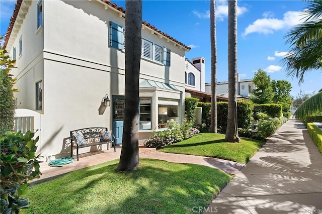 113 Via Yella, Newport Beach, CA 92663 - rear view of house featuring stucco siding, a yard, and a tiled roof