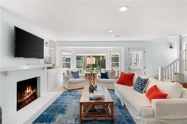 113 Via Yella, Newport Beach, CA 92663 - living area with a warm lit fireplace, stairway, wood finished floors, and recessed lighting