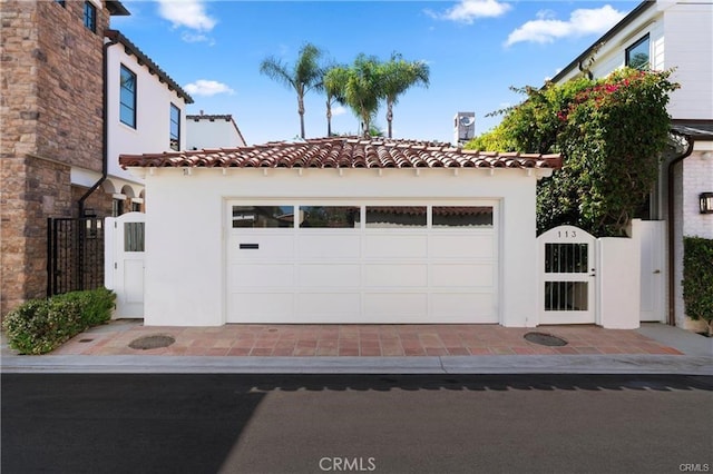 113 Via Yella, Newport Beach, CA 92663 - mediterranean / spanish-style house with a gate, a tiled roof, and stucco siding