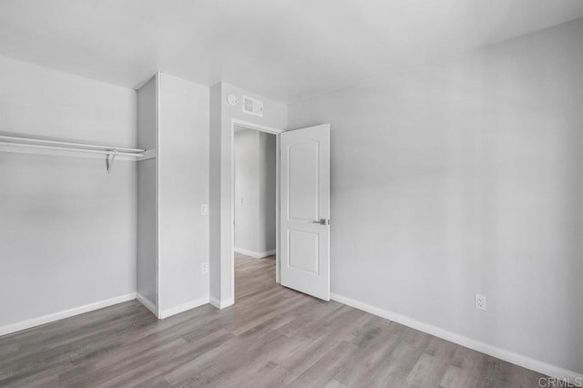 3015 Iris Ave Unit F, San Ysidro, CA 92173 - unfurnished bedroom featuring wood finished floors and a closet
