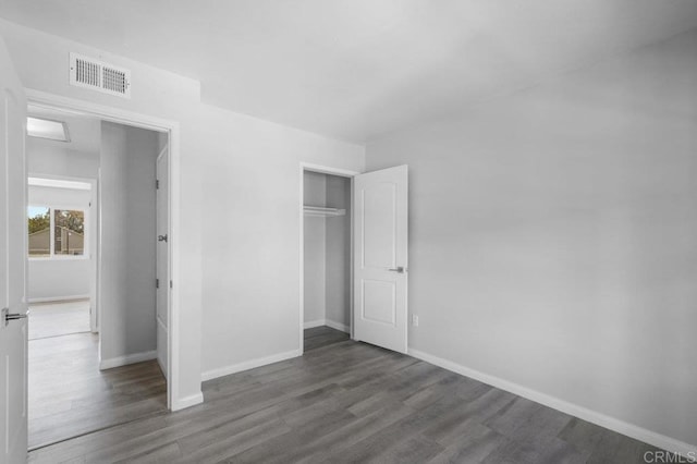 3015 Iris Ave Unit F, San Ysidro, CA 92173 - unfurnished bedroom with wood finished floors and a closet