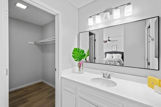 3015 Iris Ave Unit F, San Ysidro, CA 92173 - bathroom with vanity, wood finished floors, a ceiling fan, and a walk in closet