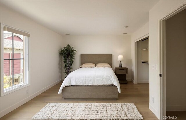 2534 Bungalow Pl Unit 87, Corona Del Mar, CA 92625 - bedroom with light wood-style flooring and baseboards