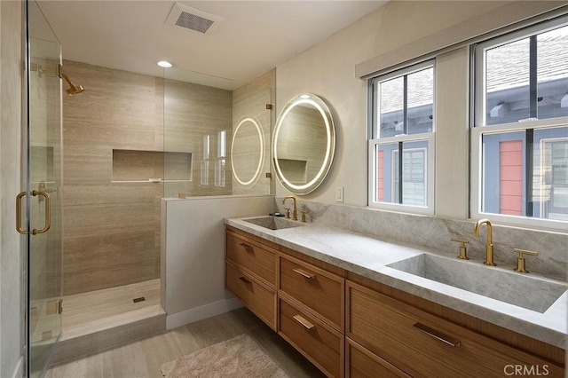 2534 Bungalow Pl Unit 87, Corona Del Mar, CA 92625 - full bathroom with a shower stall, wood finished floors, and double vanity