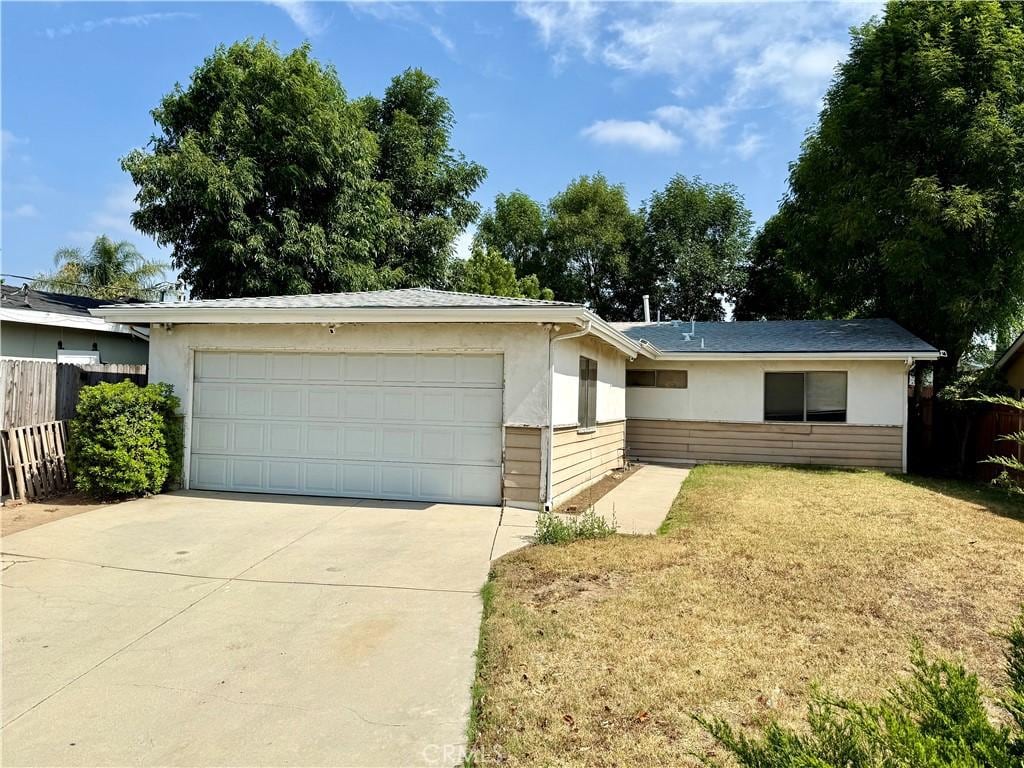 17227 Minnehaha St, Granada Hills, CA 91344 - ranch-style house with a garage, stucco siding, and driveway
