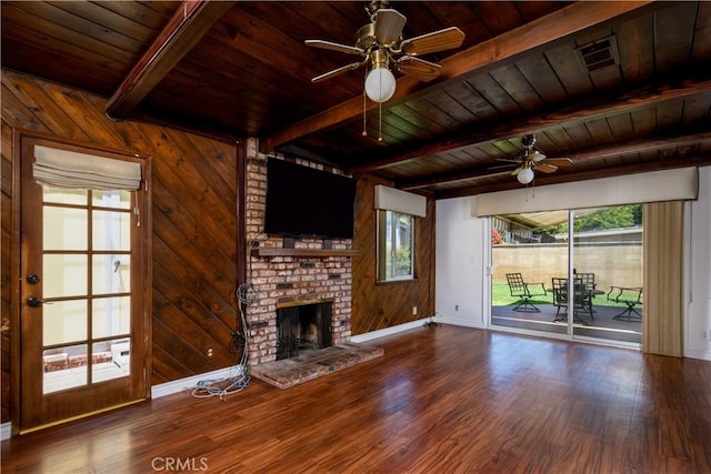 1321 Edgemont St, La Habra, CA 90631 - unfurnished living room with a wood ceiling with exposed beams, ceiling fan, a fireplace, wood finished floors, and wooden walls
