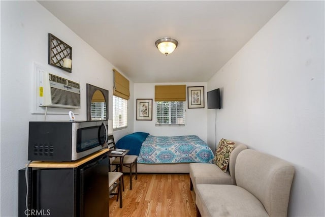 1321 Edgemont St, La Habra, CA 90631 - bedroom with light wood-type flooring and an AC wall unit
