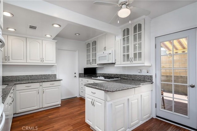 1321 Edgemont St, La Habra, CA 90631 - kitchen with white microwave, gas stovetop, glass insert cabinets, white cabinets, and a ceiling fan