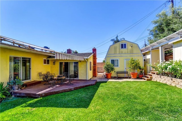 1321 Edgemont St, La Habra, CA 90631 - rear view of property featuring a wooden deck, stucco siding, a chimney, and a shed