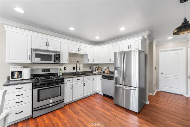 43249 42nd St W, Lancaster, CA 93536 - kitchen with stainless steel appliances, dark countertops, crown molding, white cabinets, and recessed lighting