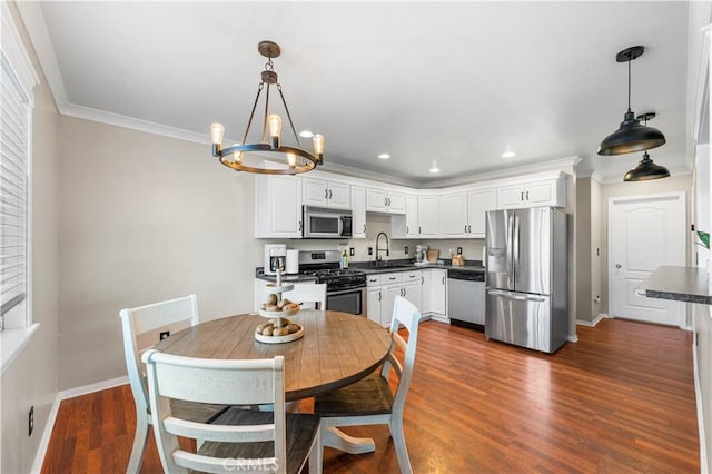43249 42nd St W, Lancaster, CA 93536 - dining space with a chandelier, recessed lighting, dark wood-type flooring, and crown molding