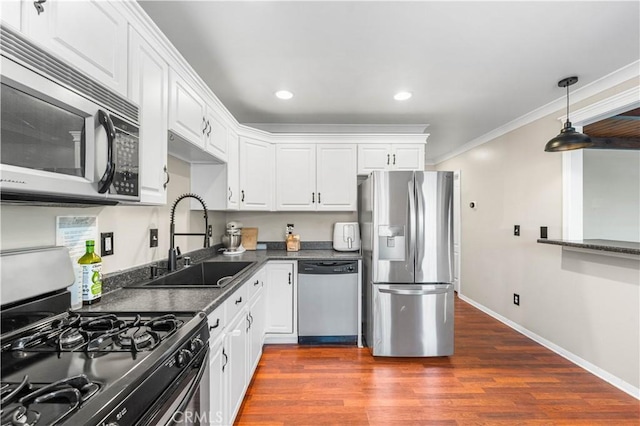 43249 42nd St W, Lancaster, CA 93536 - kitchen featuring stainless steel appliances, dark countertops, white cabinetry, dark wood-type flooring, and recessed lighting